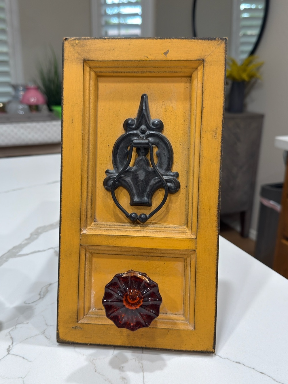 Yellow Wall Accent Panel with Black Metal Knocker and Amber Glass Knob